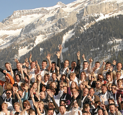 A very large group holding hands and cheering